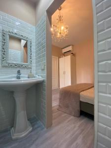 a bathroom with a sink and a bed at Casa Rosmini rooms, Dolomia best home in Trento
