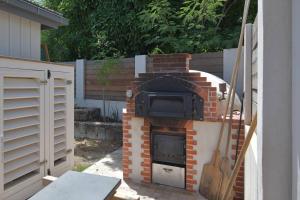 a brick oven with a tv on top of it at Case Canne a sucre in Saint Barthelemy