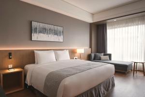 Postel nebo postele na pokoji v ubytování Grand Banyan Hotel
