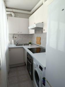 a white kitchen with a sink and a washing machine at Ciudad Universitaria - Business Area Madrid - Moncloa in Madrid