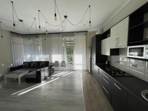 a living room with a couch and a kitchen at FAMILY apartment in Vinnytsya