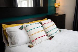 un letto con cuscini bianchi e testiera con di Saltwell Oasis: 5-Bed Delight a Low Team