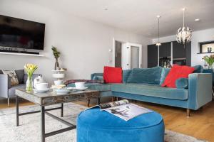 a living room with blue couches and a table at Sandpiper in Torpoint