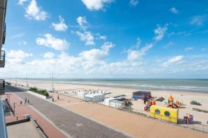 a view of a beach with a playground at Appartement met frontaal zeezicht in Koksijde