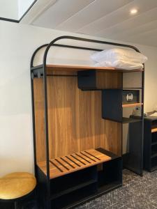 a bunk bed in a room with a chair at Hotel Vacances Bleues Villa Modigliani in Paris