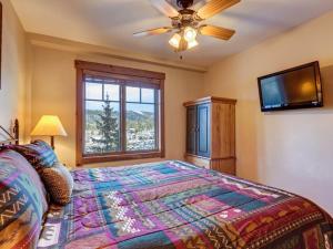 a bedroom with a bed and a ceiling fan at Breckenridge Mountain Thunder Lodge in Breckenridge