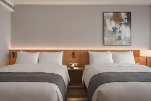 Postel nebo postele na pokoji v ubytování Grand Banyan Hotel