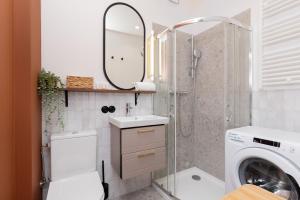 a bathroom with a sink and a washing machine at Apartment with Balcony Gdynia Downtown by Renters in Gdynia