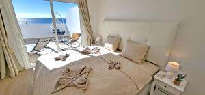 a bedroom with a large bed with bows on it at Ferienwohnung OCEAN SOUNDS 2 in Gran Tarajal