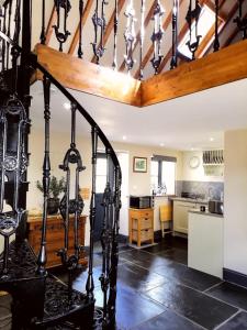 a kitchen with a staircase in a house at Stable Lodge in Berwick-Upon-Tweed
