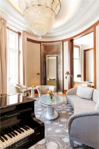 a living room with a piano and a couch at Park Hyatt Vienna in Vienna