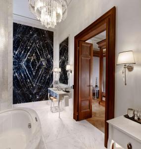 a bathroom with a tub and a sink and a mirror at Park Hyatt Vienna in Vienna