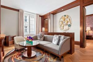 a living room with a couch and a table at Park Hyatt Vienna in Vienna