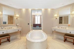a large bathroom with two sinks and a large tub at Park Hyatt Vienna in Vienna