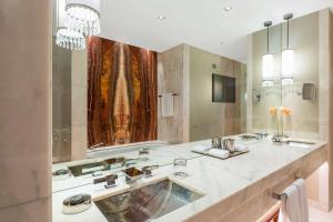 a bathroom with two sinks and a large mirror at Park Hyatt Vienna in Vienna