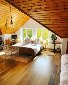 um quarto com uma cama grande num quarto com tectos em madeira em Casa din Poiana Garâna em Garana
