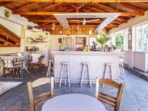 a kitchen with a bar with stools in a room at Julia Hotel in Fourka