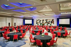 a large room with tables and red chairs at Hilton Richmond Hotel & Spa Short Pump in Richmond +38 photos