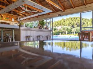 a swimming pool with a bar and chairs in a house at Julia Hotel in Fourka