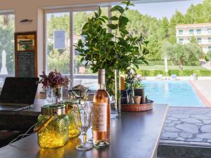 a table with a bottle of wine and glasses at Julia Hotel in Fourka
