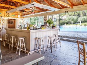 a bar in a restaurant with a swimming pool at Julia Hotel in Fourka
