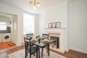 a dining room with a table and a fireplace at Stadium View, entire private house, close to city centre, free WiFi in Sheffield