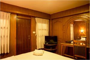 a bedroom with a bed and a television in it at Nag Pukhu Guest House in Bhaktapur