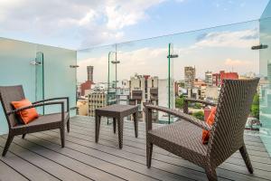 a balcony with chairs and a view of a city at Hyatt Regency Mexico City Insurgentes in Mexico City