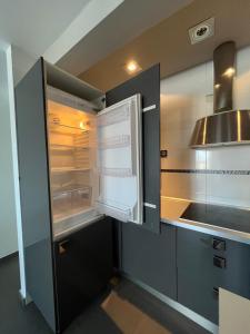 a kitchen with an empty refrigerator and a sink at Apartamento La Marquesa in Málaga