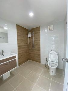 a bathroom with a toilet and a sink and a shower at โรงแรมราชิการีสอร์ท in Khon Kaen