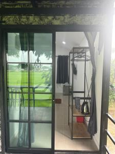 a door to a room with a view of a yard at โรงแรมราชิการีสอร์ท in Khon Kaen