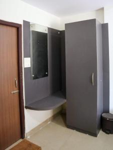 a locker room with a tv in a wall at Libra Cottage in Port Blair