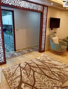 a living room with a door with a chair and a rug at شقه اكثر روعه فيو بحر مباشر in Alexandria