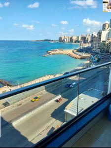 a view of a beach and the ocean from a building at شقه اكثر روعه فيو بحر مباشر in Alexandria