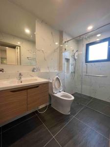 a bathroom with a toilet and a sink and a shower at Bangna 4bedroom new house luxurious discount now in Bangkok