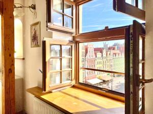 a window with a view of a city at Wroclaw Inn Apartments in Wrocław