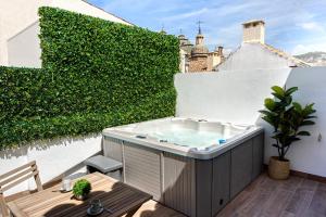 a hot tub on the balcony of a building at Genteel Home Catedral Granada in Granada