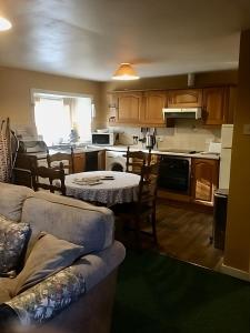 a living room with a couch and a kitchen at Pond Cottage in Covington