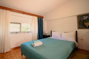a bedroom with a bed with a towel on it at Evgenias House Ancient Olympia - Happy Rentals in Olympia +10 photos