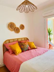 エクス・アン・プロヴァンスにあるBel appartement au calme climatisé avec terrasseのベッドルーム1室(カラフルな枕付きのベッド1台付)