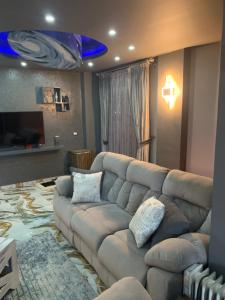 a living room with a large couch in a living room at Ismailia in Ismailia