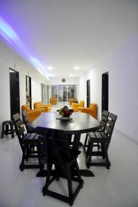 - une salle à manger avec une table, des chaises et un canapé dans l'établissement Mirador Beach Hostel, à El Prado