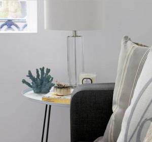 a table with a cactus on it next to a chair at Lovely 2-Bed Apartment in Stanford-le-Hope in Stanford-le-Hope