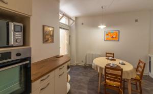 a kitchen with a table and a dining room at Rue du Barri in Cordes-sur-Ciel