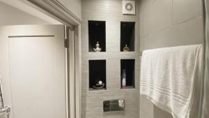 a bathroom with a shower with figurines on the wall at Remarkable 1-Bed Studio in London in London