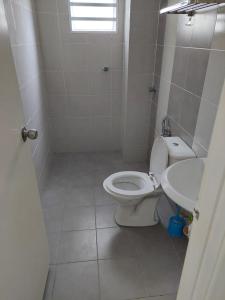 a bathroom with a toilet and a sink at 3 Bedroom Apartment with Pool and Beautiful View in Klebang, Ipoh in Chemor