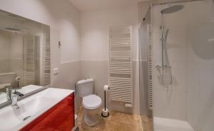 a bathroom with a sink and a toilet and a shower at Rue du Barri in Cordes-sur-Ciel