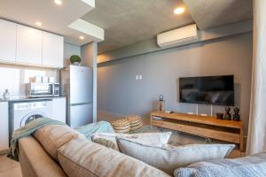 a living room with a couch and a tv at Gorgeous Coral Point Sibaya in Umdloti