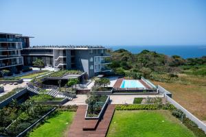 an aerial view of a resort with a swimming pool and the ocean at Gorgeous Coral Point Sibaya in Umdloti