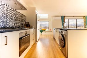 a kitchen with a washer and dryer in it at Crescent Moon in Lake Tekapo